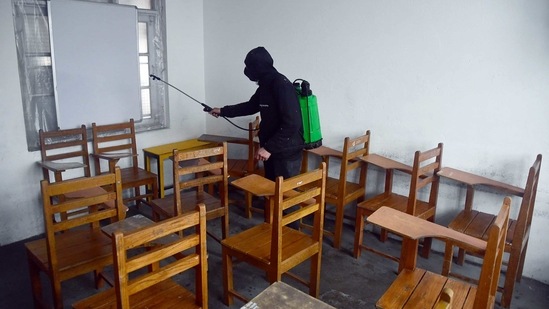 A worker sanitizes the classrooms ahead of the opening of schools after the COVID-19 outbreak, in Srinagar on Saturday. (ANI Photo)