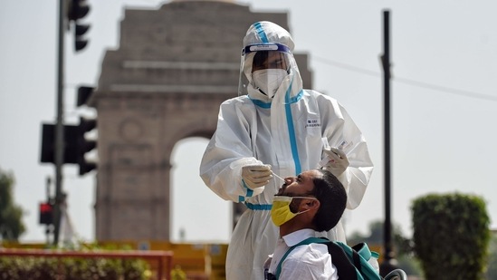 A healthcare worker collects the swab sample for Covid-19 testing from a person at India Gate in New Delhi. (ANI Photo) A healthcare worker collects the swab sample for Covid-19 testing from a person at India Gate in New Delhi. (ANI Photo)
