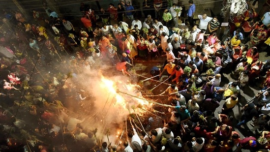 People participate in 'Holika Dahan' on the eve of the Holi festival, in Patna on Sunday. (ANI Photo) People participate in 'Holika Dahan' on the eve of the Holi festival, in Patna on Sunday. (ANI Photo)