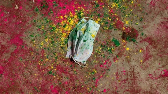 A face mask lies on a road covered with coloured powder during Holi celebrations, amidst the spread of the coronavirus disease (Covid-19), in Chennai on March 29.(P. Ravikumar/REUTERS)