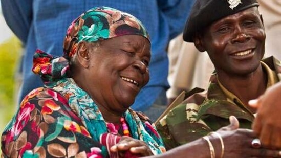 Sarah Obama, step-grandmother of then US President Barack Obama, shakes the hand of a well-wisher after speaking to the media in the garden of her home in the village of Kogelo, western Kenya.(AP)