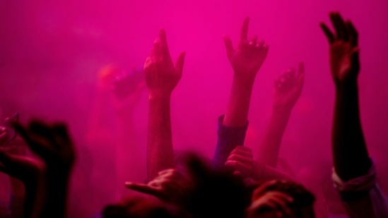 People dancing during Holi celebrations in Guwahati on March 29. Health experts worry that unchecked gatherings can lead to clusters, adding the situation can be controlled if vaccination is opened up for more people and Covid-19 protocols are strictly followed.(Anupam Nath/AP)