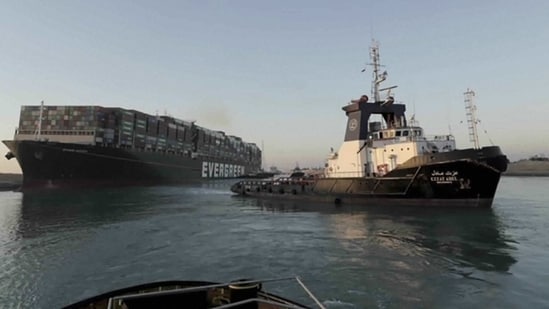 In this photo released by Suez Canal Authority, the Ever Given, a Panama-flagged cargo ship is pulled by one of the Suez Canal tugboats, in the Suez Canal, Egypt, Monday, March 29, 2021. (AP)
