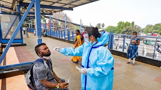 A health worker takes a swab sample from a man for the Covid-19 test, at Kempegowda bus stand in Bengaluru.(PTI)