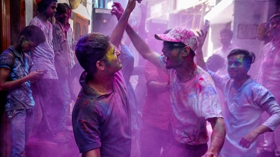 Residents dance in a street as they celebrate the Holi festival, in Lucknow.(PTI) Residents dance in a street as they celebrate the Holi festival, in Lucknow.(PTI)