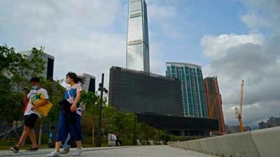 People walk in front of "M+" visual culture museum in the West Kowloon Cultural District of Hong Kong,(AP)