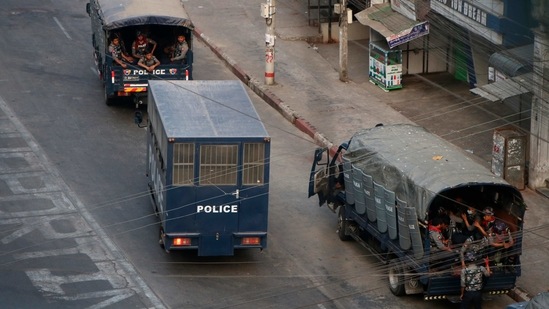 Security forces in trucks with a bus for people in custody stand by on Hledan road in Kamayut township of Yangon in Myanmar, on Monday, March 29, 2021. (AP)