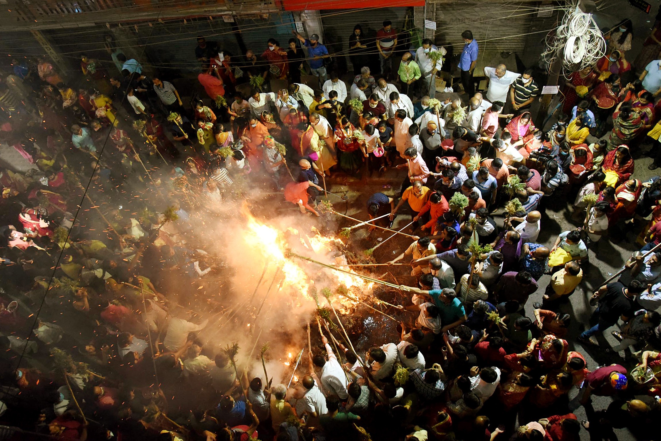 People participate in 'Holika Dahan' on the eve of the Holi festival, in Patna on Sunday. (ANI Photo) People participate in 'Holika Dahan' on the eve of the Holi festival, in Patna on Sunday. (ANI Photo)