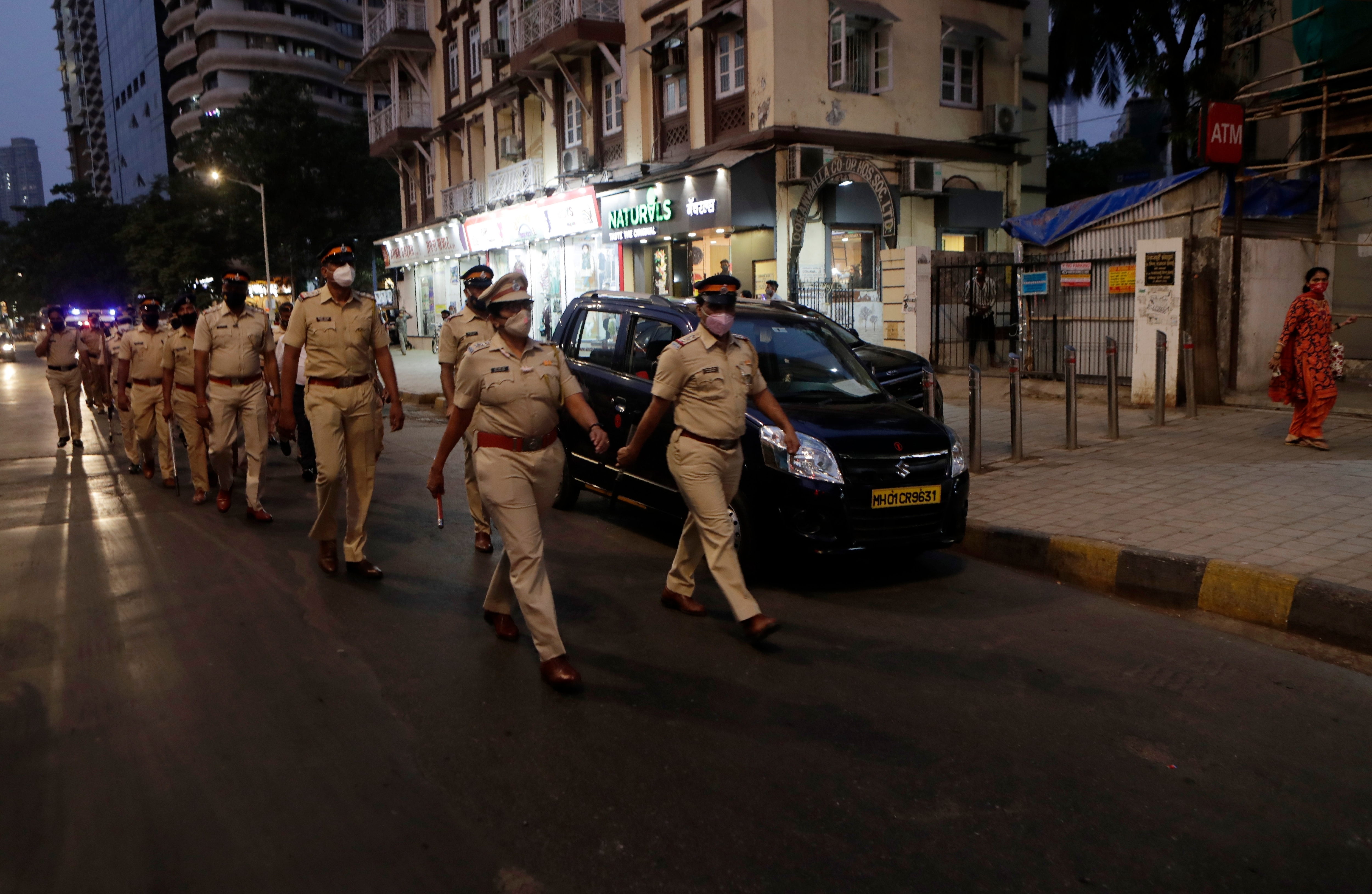 Police officials conduct a flag march during the night curfew imposed by the authorities following the rise in COVID-19 cases in Mumbai, India, Sunday, March 28, 2021. (AP) Police officials conduct a flag march during the night curfew imposed by the authorities following the rise in COVID-19 cases in Mumbai, India, Sunday, March 28, 2021. (AP)