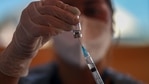 A healthcare worker prepares a dose of the Sinovac COVID-19 vaccine at a drive-thru vaccination site during a city-wide lockdown that has been reinstated to help contain the spread of COVID-19 in Santiago, Chile, Saturday, March 27, 2021. (AP Photo/Esteban Felix)(AP)