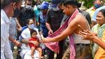 West Bengal chief minister Mamata Banerjee holds a child during her election campaign roadshow for the assembly polls, in Nandigram, Monday. (PTI)