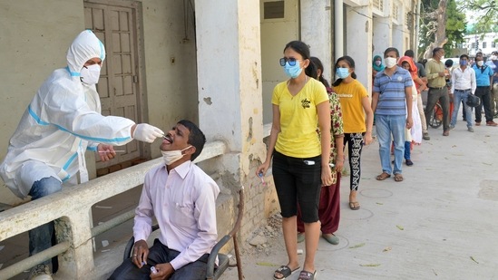 A health worker in the PPE kit collects a swab sample for the Covid-19 test, in Agra on Tuesday. (ANI) A health worker in the PPE kit collects a swab sample for the Covid-19 test, in Agra on Tuesday. (ANI)