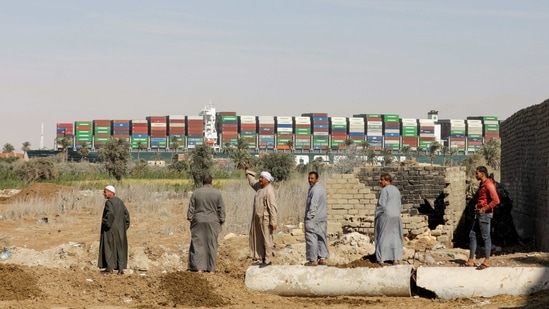People look on as the Ever Given container ship refloats in Suez Canal, Egypt March 29. After dredging and excavation work over the weekend, rescue workers from the Suez Canal Authority (SCA) and a team from Dutch firm Smit Salvage had succeeded in partially refloating the ship earlier on March 29 using tug boats, two marine and shipping sources told Reuters.(Mohamed Abd El Ghany / REUTERS)