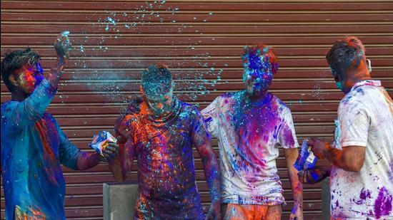 People play with dry colours on Holi at Paharganj, New Delhi, on Monday, March 29. (PTI)