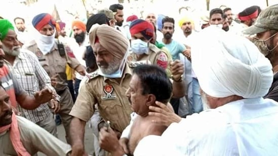 Farmers roughing up BJP MLA Arun Narang at Malout town in Muktsar district on Saturday. (Sanjeev Kumar/HT) Farmers roughing up BJP MLA Arun Narang at Malout town in Muktsar district on Saturday. (Sanjeev Kumar/HT)