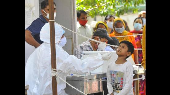 A health worker collecting swab samples for Covid-19 testing at the Sector-45 Civil Hospital in Chandigarh. (Keshav SIngh/HT) A health worker collecting swab samples for Covid-19 testing at the Sector-45 Civil Hospital in Chandigarh. (Keshav SIngh/HT)