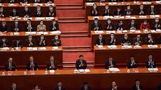 China's President Xi Jinping (C) applauds with other leaders and delegates after the result of the vote on changes to Hong Kong's election system was announced.(AFP)