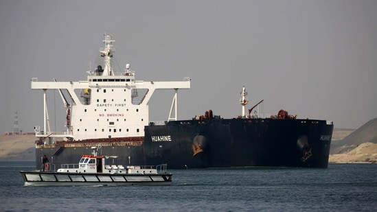 Ismailia : A cargo ship sails through the town of Ismailia, Egypt, Tuesday, March 30, 2021 as traffic resumed through the Suez canal after it was blocked by a massive ship that had been stuck sideways for nearly a week. (AP)
