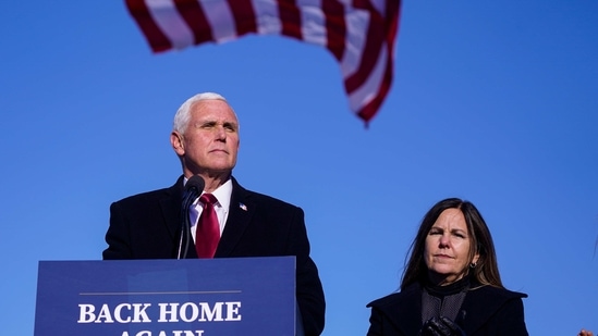 FILE - In this Jan. 20, 2021, file phot, former Vice President Mike Pence speaks after arriving back in his hometown of Columbus, Ind., as his wife Karen watches. Pence is steadily re-entering public life as he eyes a potential run for the White House in 2024. He's writing op-eds, delivering speeches, preparing trips to early voting states and launching an advocacy group likely to focus on promoting the accomplishments of the Trump administration. (AP Photo/Michael Conroy, File)(AP)