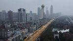 (FILES) In this file photo taken on January 27, 2020 an aerial view shows residential and commercial buildings of Wuhan in China's central Hubei province, amid a deadly virus outbreak which began in the city. - An international expert mission to Wuhan has concluded that it was very likely that Covid first passed to humans from a bat through an intermediary animal, while all but ruling out a lab incident. The experts said that the intermediary host hypothesis was deemed "likely to very likely", while the theory that the virus escaped from a laboratory was seen as "extremely unlikely", according to the final version of the long-awaited report, of which AFP obtained a copy on March 29, 2021 before the official release. (Photo by Hector RETAMAL / AFP)(AFP) (FILES) In this file photo taken on January 27, 2020 an aerial view shows residential and commercial buildings of Wuhan in China's central Hubei province, amid a deadly virus outbreak which began in the city. - An international expert mission to Wuhan has concluded that it was very likely that Covid first passed to humans from a bat through an intermediary animal, while all but ruling out a lab incident. The experts said that the intermediary host hypothesis was deemed "likely to very likely", while the theory that the virus escaped from a laboratory was seen as "extremely unlikely", according to the final version of the long-awaited report, of which AFP obtained a copy on March 29, 2021 before the official release. (Photo by Hector RETAMAL / AFP)(AFP)