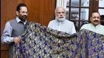 New Delhi: Prime Minister Narendra Modi hands over a Chaadar to be offered at Dargah Khwaja Moinuddin Chishti, Ajmer Sharif to the minority affairs minister Mukhtar Abbas Naqvi (PTI) New Delhi: Prime Minister Narendra Modi hands over a Chaadar to be offered at Dargah Khwaja Moinuddin Chishti, Ajmer Sharif to the minority affairs minister Mukhtar Abbas Naqvi (PTI)