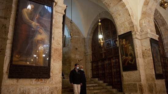 Amit Re'em, Jerusalem regional archaeologist for Israel Antiquities Authority and Father Samuel Aghoyan, the Armenian superior at the Church of the Holy Sepulchre, walk in the Saint Helena chapel inside the church which is revered in Christian tradition as the site of Jesus' crucifixion, during an interview with Reuters, in Jerusalem's Old City February 24, 2021. (REUTERS)
