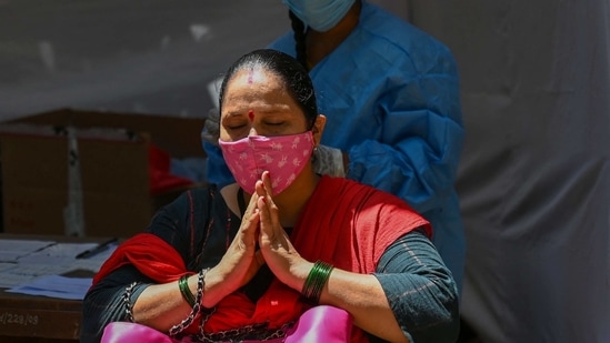 A woman prays before giving a nasal swab sample for a Covid-19 test, outside the Sessions Court in Mumbai, on March 31. Maharashtra registered 27,918 new Covid-19 cases and 139 deaths on March 30 with which the state’s cumulative count of Covid-19 infections surged to 2,773,436 and the death toll mounted to 54,422.(Punit Paranjpe / AFP)