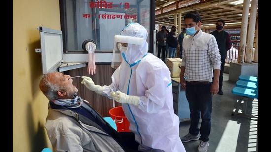 The nasopharyngeal sample of CPI(M) MLA Rakesh Singha being collected at Deen Dayal Upadhyay Government Hospital in Shimla on March 27. The highest single-day spike of this year was also recorded on Saturday when 416 people tested positive in Himachal Pradesh. (Deepak Sansta/HT)
