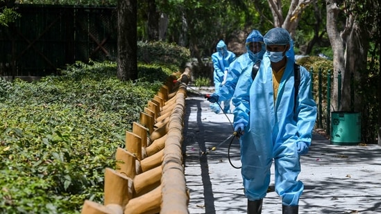 National Zoological Park employees sanitise the premises in New Delhi on March 31. India has been recording a daily spike of over 60,000 cases for a few days until March 29.(Prakash Singh / AFP)
