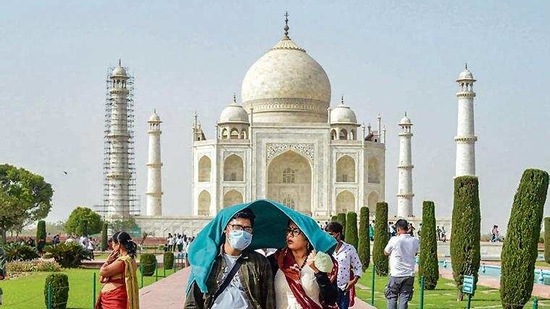 Tourists take shade from the scorching sun at the Taj Mahal. (PTI) Tourists take shade from the scorching sun at the Taj Mahal. (PTI)