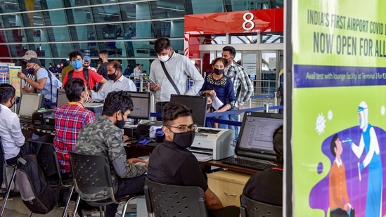 Passengers at a Covid-19 lab, at IGI Airport in New Delhi. (PTI) Passengers at a Covid-19 lab, at IGI Airport in New Delhi. (PTI)