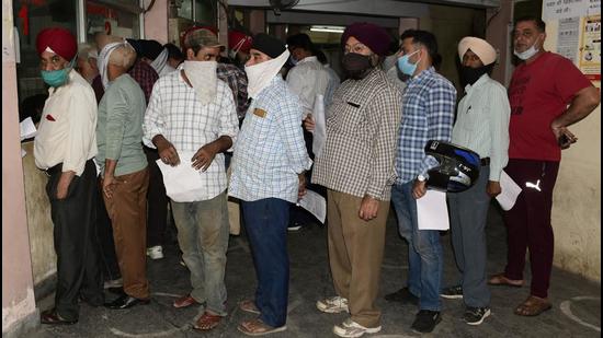Residents queue up to deposit property tax at Zone A Suwidha Kendra in Ludhiana on Wednesday. (Harsimar Pal Singh/HT)