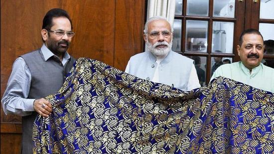 New Delhi: Prime Minister Narendra Modi hands over a Chaadar to be offered at Dargah Khwaja Moinuddin Chishti, Ajmer Sharif to the minority affairs minister Mukhtar Abbas Naqvi (PTI)