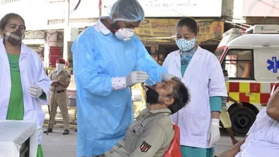 People undergoing a Covid test in Ludhiana. Punjab chief minister Capt Amarinder Singh has ordered that testing and vaccination be stepped up and sites be opened in busy market areas, bus stands and railway stations. (Gurpreet Singh/HT) People undergoing a Covid test in Ludhiana. Punjab chief minister Capt Amarinder Singh has ordered that testing and vaccination be stepped up and sites be opened in busy market areas, bus stands and railway stations. (Gurpreet Singh/HT)