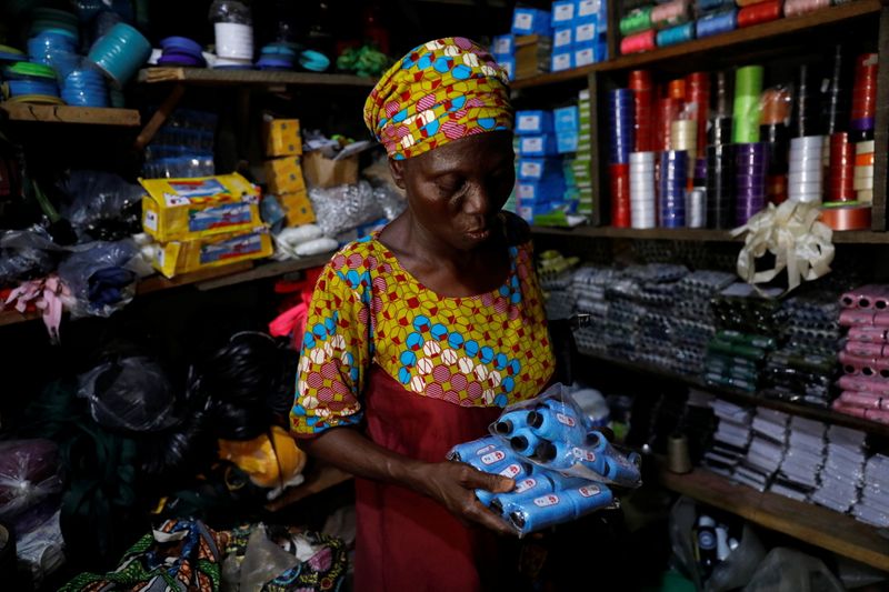 Shade Ajayi, 50, shops for thread for her bag-making business, at a store in Ilorin, Kwara state. (REUTERS)