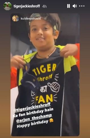 The young boy shows off his t-shirt. The young boy shows off his t-shirt.
