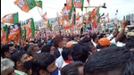 BJP supporters carry party flags during the roadshow of defence minister Rajnath Singh in Udhagmandalam, ahead of the assembly elections, on March 31. (ANI) BJP supporters carry party flags during the roadshow of defence minister Rajnath Singh in Udhagmandalam, ahead of the assembly elections, on March 31. (ANI)