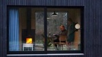 Guy De Deyn and his partner Kim Devos enjoy a wood fire as they read a book together in a Slow Cabin in Elewijt, Belgium, Monday, Feb. 15, 2021. (AP) Guy De Deyn and his partner Kim Devos enjoy a wood fire as they read a book together in a Slow Cabin in Elewijt, Belgium, Monday, Feb. 15, 2021. (AP)