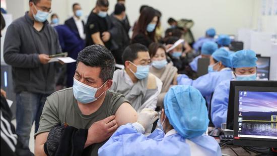 Residents queue to receive the Sinovac Covid-19 vaccine in Lianyungang in China's eastern Jiangsu province on Thursday. (AFP)