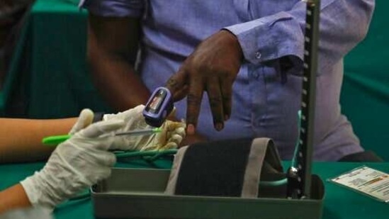 A doctor checks the vital statistics of a man before administering him a Covid-19 vaccine, at Government Fever Hospital, in Hyderabad, on April 1. So far vaccine doses have been administered to 82,60,293 health care workers (1st dose), 52,50,704 health care workers (2nd dose), 91,74,171 frontline workers (1st dose) and 39,45,796 frontline workers (2nd Dose), senior citizens and those with comorbidities 78,36,667(1st dose) and 17,849 (2nd dose), PTI reported citing Health Ministry data.(Mahesh Kumar A. / AP)
