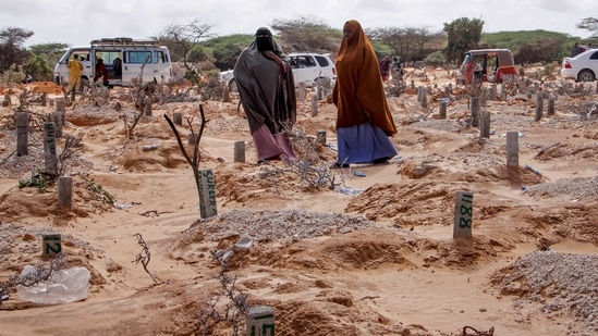 FILE - In this May, 13, 2020, file photo, women walk past graves at a cemetery in Mogadishu, Somalia, following the burial of a man who died of COVID-19. Africa has surpassed 100,000 confirmed deaths from COVID-19 as the continent praised for its early response to the pandemic now struggles with a dangerous resurgence and medical oxygen often runs desperately short. (AP Photo/Farah Abdi Warsameh, File) (AP) FILE - In this May, 13, 2020, file photo, women walk past graves at a cemetery in Mogadishu, Somalia, following the burial of a man who died of COVID-19. Africa has surpassed 100,000 confirmed deaths from COVID-19 as the continent praised for its early response to the pandemic now struggles with a dangerous resurgence and medical oxygen often runs desperately short. (AP Photo/Farah Abdi Warsameh, File) (AP)