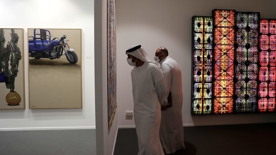 People visit the 14th edition of Art Dubai at Dubai International Financial Centre, DIFC, which features 50 galleries from 31 countries with a focus on modern and contemporary art, in Dubai, United Arab Emirates, Tuesday, March 30, 2021. (AP)