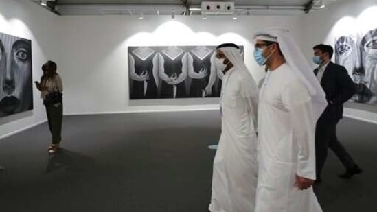 People visit Ayyam gallery of the 14th edition of Art Dubai at Dubai International Financial Centre, DIFC, which features 50 galleries from 31 countries with a focus on modern and contemporary art, in Dubai, United Arab Emirates, Tuesday, March 30, 2021. (AP Photo/Kamran Jebreili)(AP)