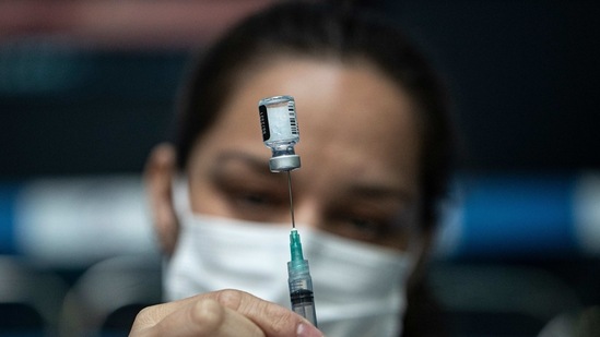 A healthcare worker prepares a dose of the Pfizer COVID-19 vaccine at the Victor Jarra stadium during a city-wide lockdown reinstated to help contain the spread of COVID-19 in Santiago, Chile, Tuesday, March 30, 2021. (AP Photo/Esteban Felix)(AP) A healthcare worker prepares a dose of the Pfizer COVID-19 vaccine at the Victor Jarra stadium during a city-wide lockdown reinstated to help contain the spread of COVID-19 in Santiago, Chile, Tuesday, March 30, 2021. (AP Photo/Esteban Felix)(AP)