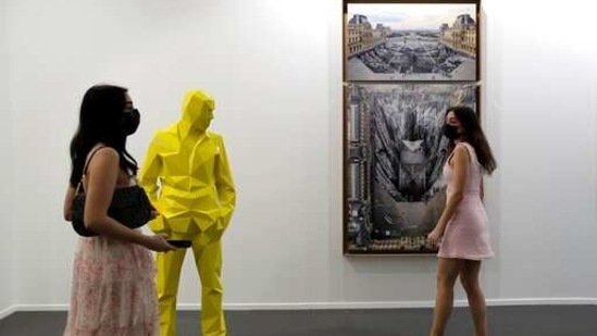 People visit Perrotin gallery of the 14th edition of Art Dubai at Dubai International Financial Centre, DIFC, which features 50 galleries from 31 countries with a focus on modern and contemporary art, in Dubai, United Arab Emirates, Tuesday, March 30, 2021. (AP)