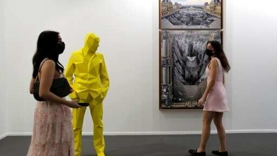 People visit Perrotin gallery of the 14th edition of Art Dubai at Dubai International Financial Centre, DIFC, which features 50 galleries from 31 countries with a focus on modern and contemporary art, in Dubai, United Arab Emirates, Tuesday, March 30, 2021. (AP)