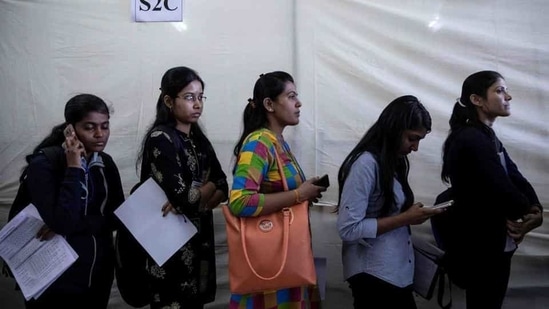 Job seekers wait in a queue for interviews at a job fair. Job seekers wait in a queue for interviews at a job fair.