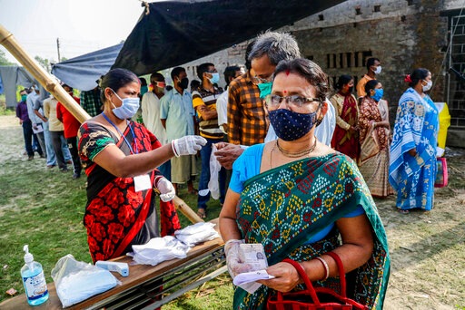 Voters stand in a queue at a makeshift polling booth during the second phase of elections for West Bengal state in Nandigram , East Medinipur district, India, Thursday, April 1, 2021. (AP Photo/Bikas Das) (AP) Voters stand in a queue at a makeshift polling booth during the second phase of elections for West Bengal state in Nandigram , East Medinipur district, India, Thursday, April 1, 2021. (AP Photo/Bikas Das) (AP)