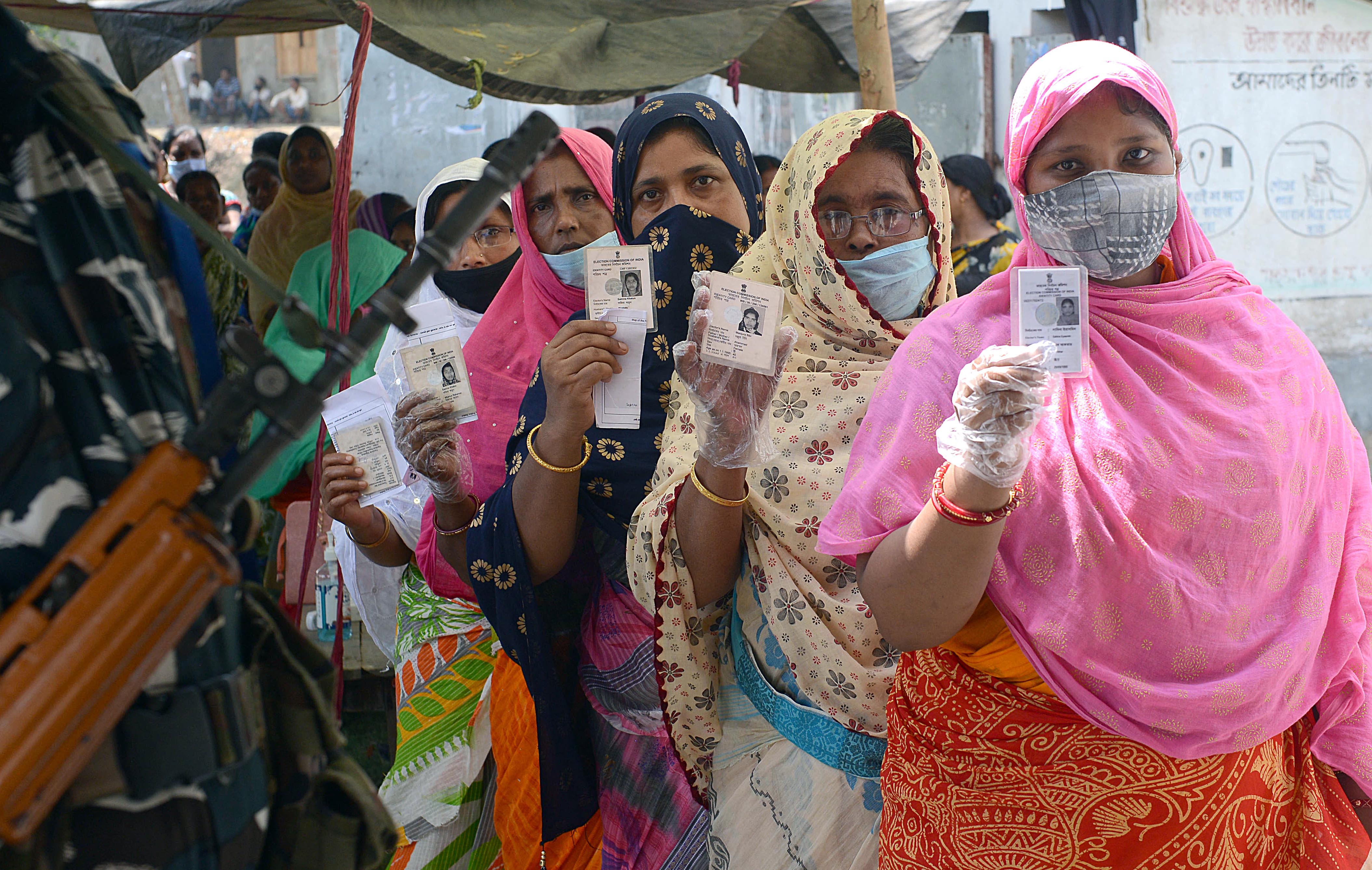 Female voters showing their voter ID card before casting vote outside a polling station during the second phase of West Bengal Assembly polls, in Nandigram on Thursday. (ANI Photo) Female voters showing their voter ID card before casting vote outside a polling station during the second phase of West Bengal Assembly polls, in Nandigram on Thursday. (ANI Photo)