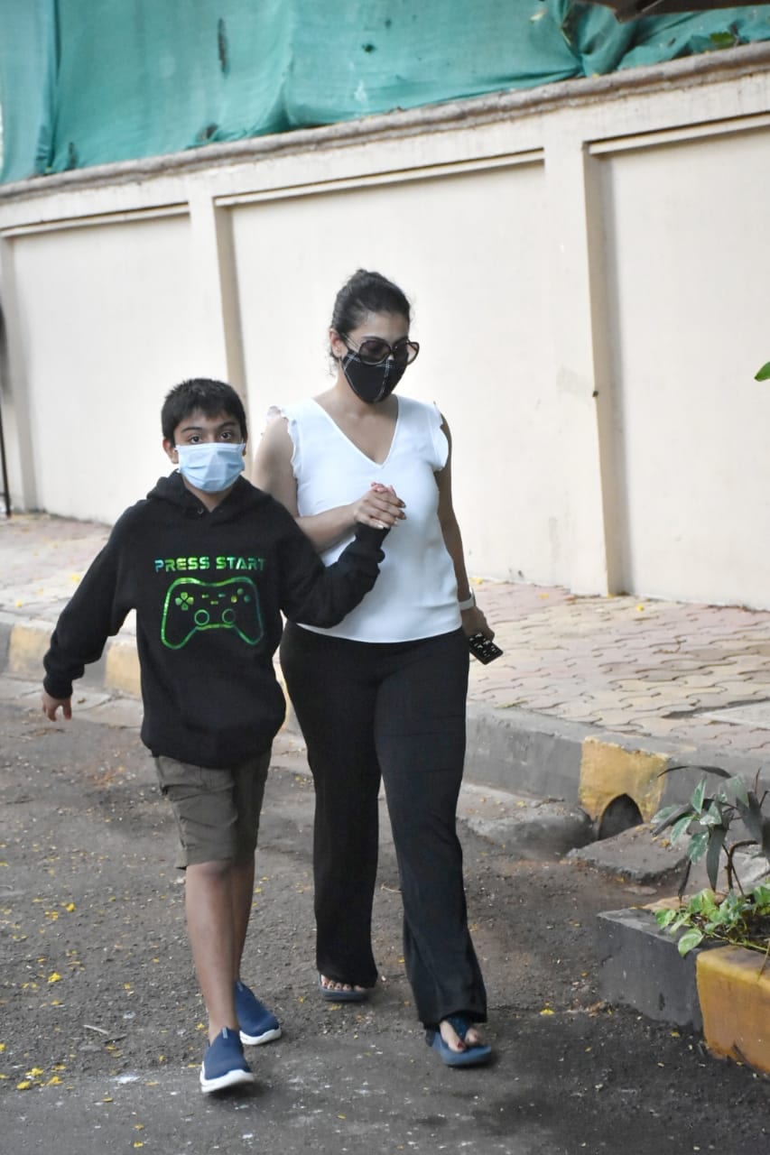 Kajol seen with her son Yug. She held his hand as they walked by some photographers. Kajol seen with her son Yug. She held his hand as they walked by some photographers.